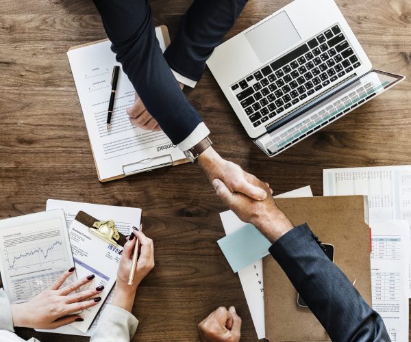 Business people shaking hands together